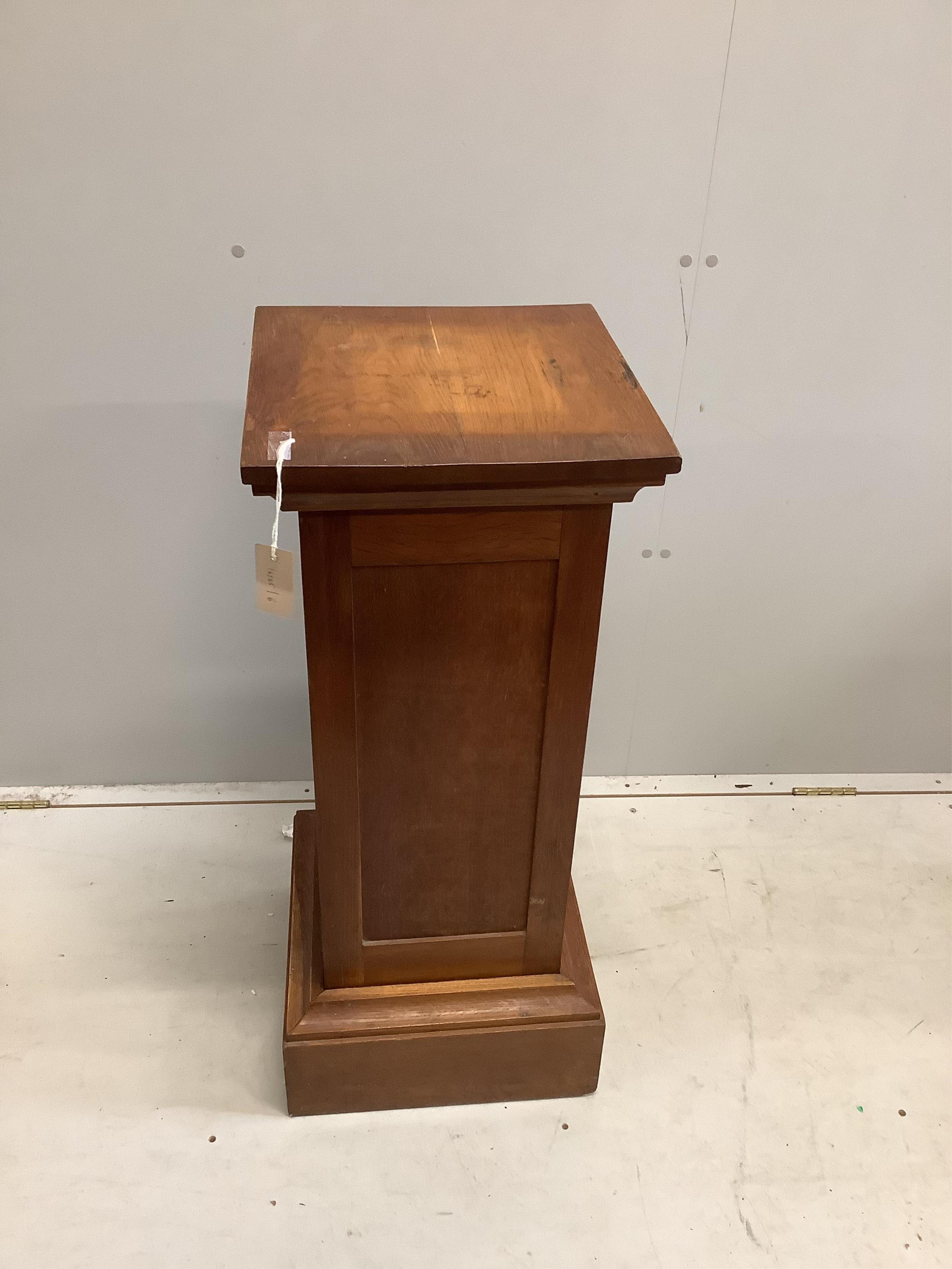 An early 20th century oak pedestal, width 37cm, height 90cm. Condition - fair